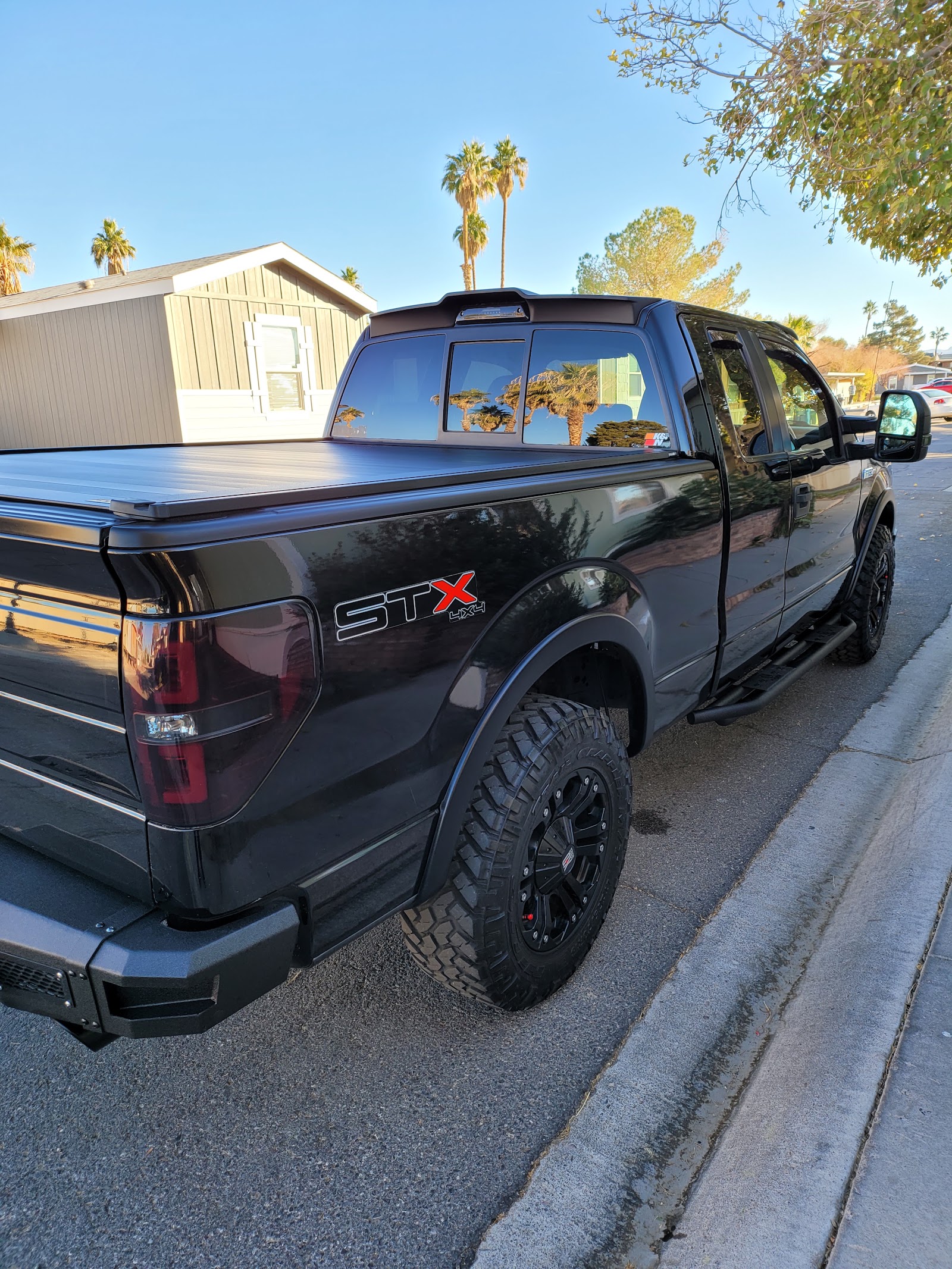 Freshly washed black Ford F-150 STX 4x4 with a shiny finish