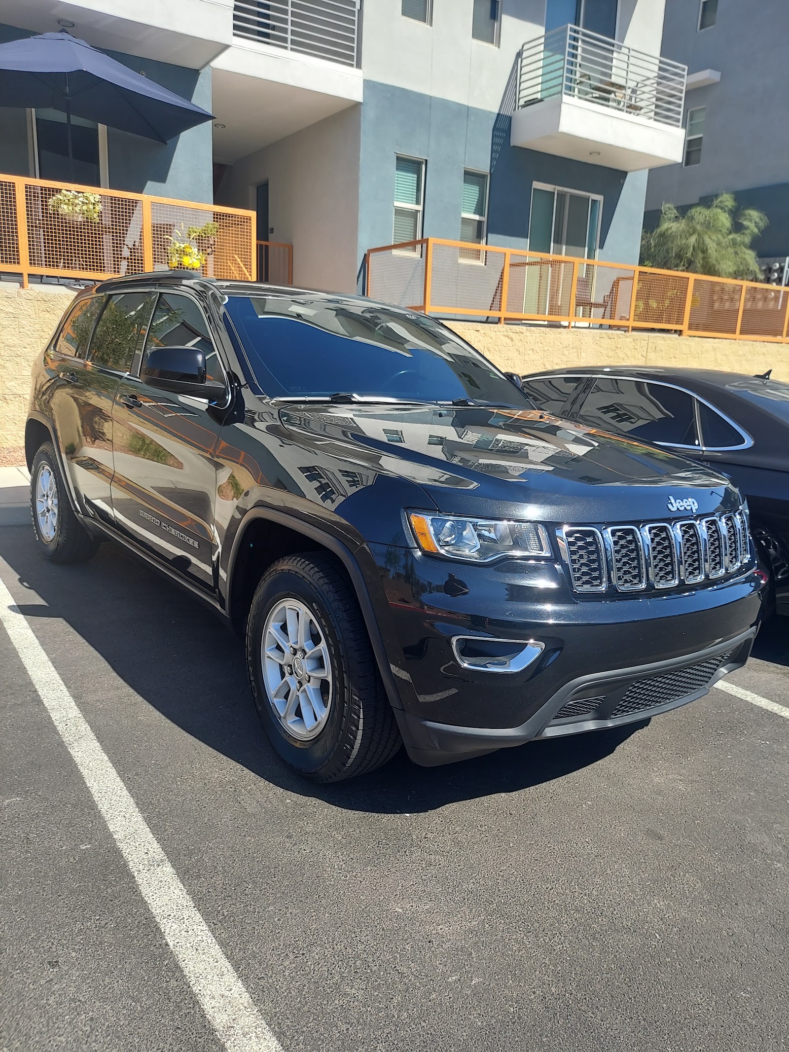 Clean black Jeep Grand Cherokee with a reflective glossy finish